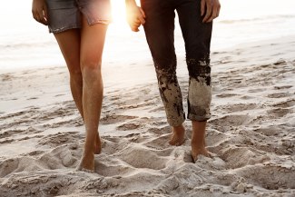 couple holding hands on the beach