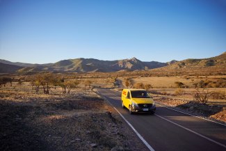 DHL van driving on a desert road